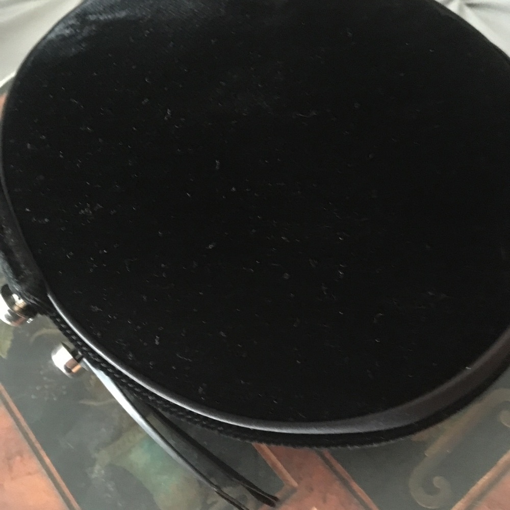 Pillbox hat, black, decorative buttons.
